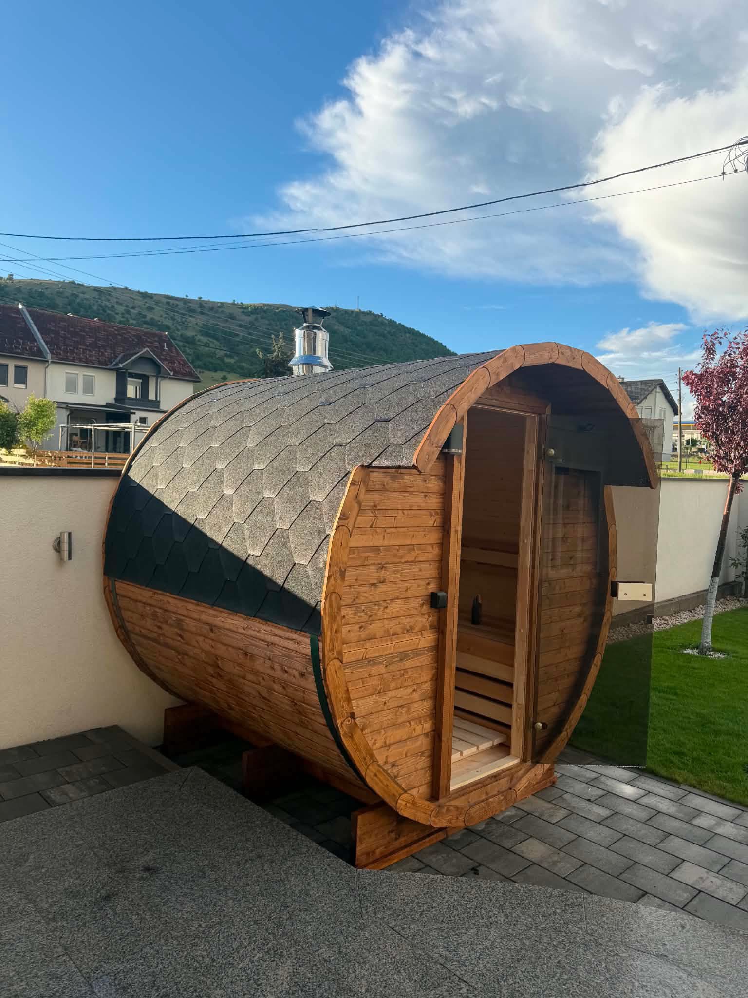 Kim's Jacuzzi barrel sauna installed in a residential garden under blue sky
