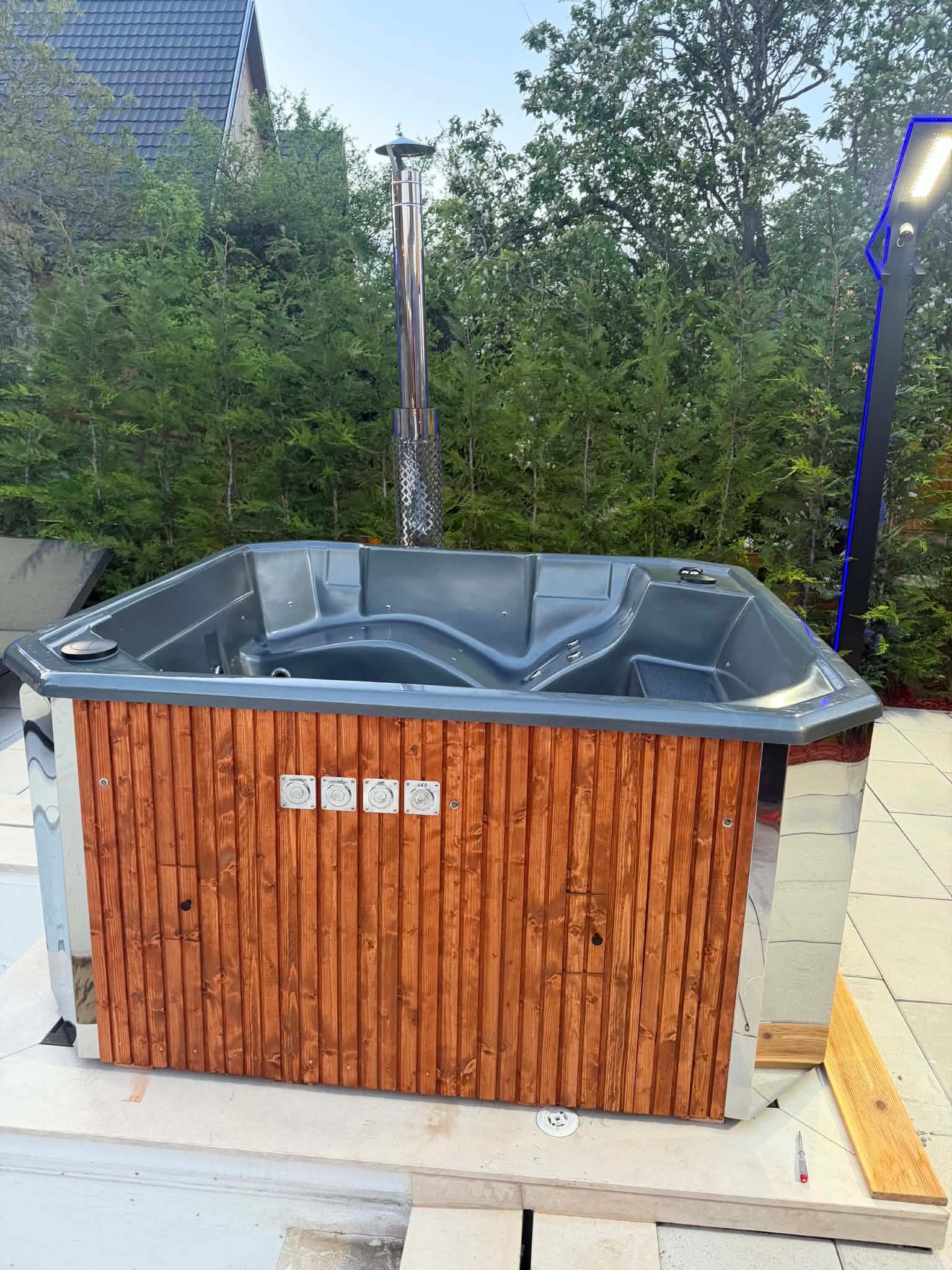 Kim's Jacuzzi pod sauna glowing with warm amber light at night